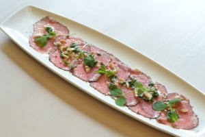 Beef carpaccio with smoked almonds and chimichurri