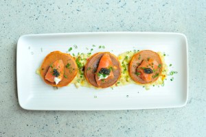 Jams red pepper pancakes with smoked salmon, corn sauce, creme fraiche and caviar