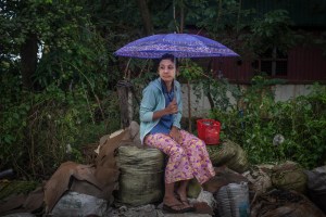 A factory worker sits in protest outside of the Nadia Pacific Apparel Co. Ltd. on October 13, 2015. On August 29 2015, the government of Myanmar announced a minimum wage of 3,600 kyats (about 3 US$). This slight pay raise was met with hostilities by factory owners in the Garment Industries who either refused to increase pay at all, made layoffs to keep expenses the same or cut overtime pay and benefits. Even those garment factory workers who have seen a increase in their daily wages have seen very little change in their salaries overall.