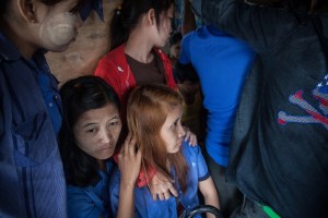 Factory workers listen to their Union Leader speak on October 13, 2015. On August 29 2015, the government of Myanmar announced a minimum wage of 3,600 kyats (about 3 US$). This slight pay raise was met with hostilities by factory owners in the Garment Industries who either refused to increase pay at all, made layoffs to keep expenses the same or cut overtime pay and benefits. Even those garment factory workers who have seen a increase in their daily wages have seen very little change in their salaries overall.