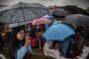 Factory workers listen to their Union Leader speak on October 13, 2015. On August 29 2015, the government of Myanmar announced a minimum wage of 3,600 kyats (about 3 US$). This slight pay raise was met with hostilities by factory owners in the Garment Industries who either refused to increase pay at all, made layoffs to keep expenses the same or cut overtime pay and benefits. Even those garment factory workers who have seen a increase in their daily wages have seen very little change in their salaries overall.