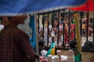 Factory workers listen to their Union Leader speak on October 13, 2015. On August 29 2015, the government of Myanmar announced a minimum wage of 3,600 kyats (about 3 US$). This slight pay raise was met with hostilities by factory owners in the Garment Industries who either refused to increase pay at all, made layoffs to keep expenses the same or cut overtime pay and benefits. Even those garment factory workers who have seen a increase in their daily wages have seen very little change in their salaries overall.