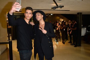 Olivier Rousteing and a die-hard fan inside the H&M Champs-Elysees flagship store
