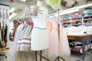 Costumes for Marie and the Sugarplum Fairy on a finished rack.