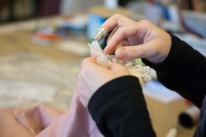 A costume shop employee finishes a ruffle at New York City Ballet