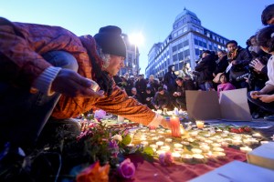 People light candles at the Place de la Bourse in Brussels following the attacks.