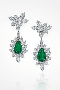 A pair of diamond and emerald ear pendants by Harry Winston.