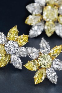 A pair of colored diamond and diamond ear clips by Cartier.