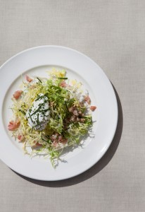 A frisée salad with poached egg and lardons at Holiday Café