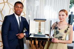 John Boyega and Bel Powley with the Chopard Trophy.