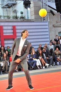 Rafael Nadal playing futnet in Tommy Hilfiger suit.