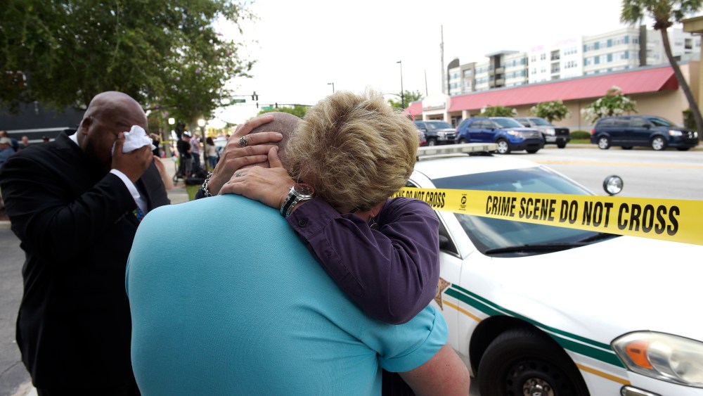 Terry DeCarlo, executive director of the LGBT Center of Central Florida, center, is comforted by Orlando City Commissioner Patty Sheehan, right, after a shooting involving multiple fatalities at a nightclub in Orlando, Fla., Sunday, June 12, 2016.