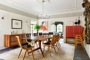 Nickey Kehoe used a mix of styles and periods to update Storybook architecture in a refreshing way. Roland Rainer chairs, a George Nakashima credenza, and a Josef Frank cabinet for Svenskt Tenn all happily share the space with an antique carpet.
