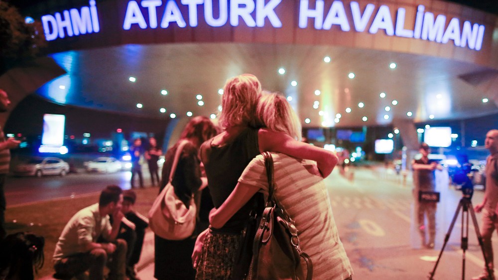 Passengers outside the entrance to Istanbul's Ataturk airport following their evacuation after the attack.