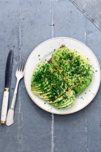 Thinly sliced avocado open-faced sandwich on rye bread at Café Atelier September