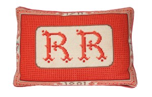 A monogrammed pillow given to President Reagan on his 70th birthday by interior decorator Ted Graber.