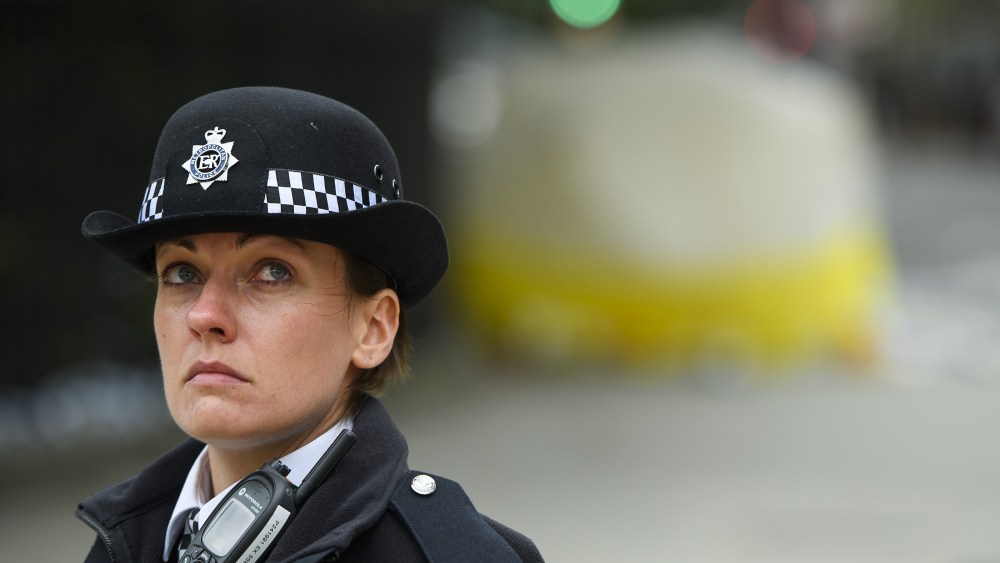 Police stand in front of an evidence tent at the site of an incident in Russell Square where one woman was killed and five others were injured.