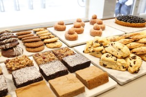 An assorted selection of bars, cookies, scones and brioche doughnuts.