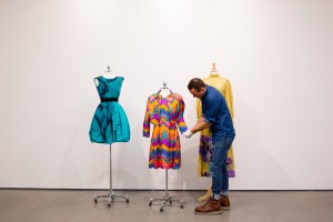 An Uovo handler switching out looks from the Oscar de la Renta archive.