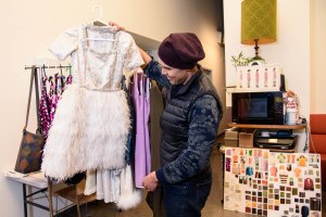 Clint Ramos holding up one of his designs for "Sweet Charity."