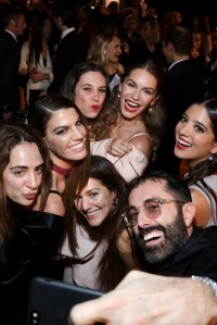 Giambattista Valli leads a group selfie at the Azzaro presentation