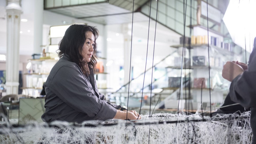 Chiharu Shiota working on her Installation at Le Bon Marché.