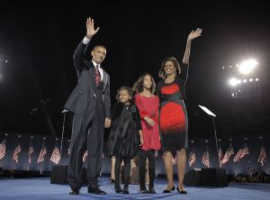 Barack Obama, Michelle Obama in Narciso Rodriguez, Malia Obama, and Sasha Obama as they wave at the 2008 election night rally in Chicago.