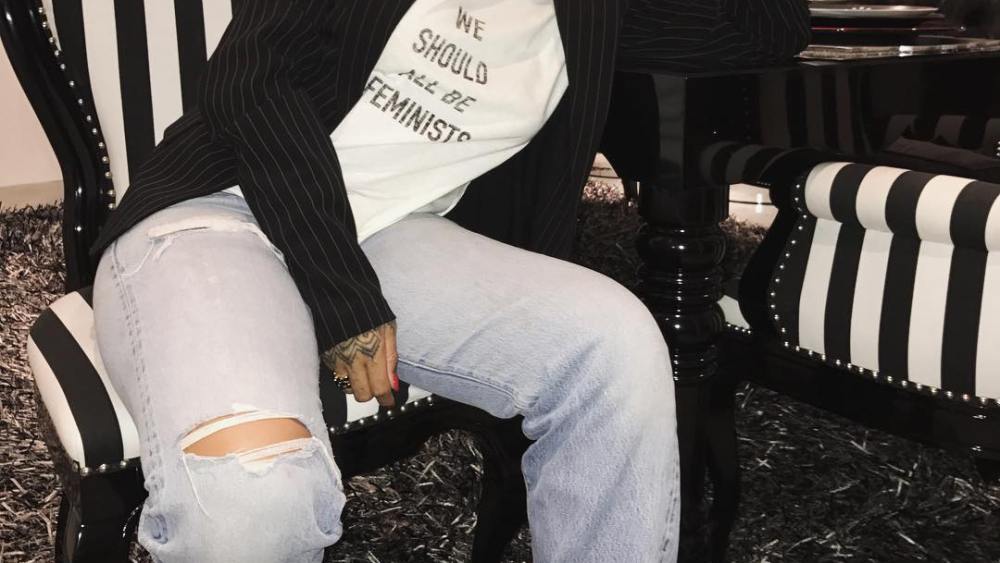 Rihanna wearing a Dior T-shirt from a collaboraton with Rihanna's The Clara Lionel Foundation.