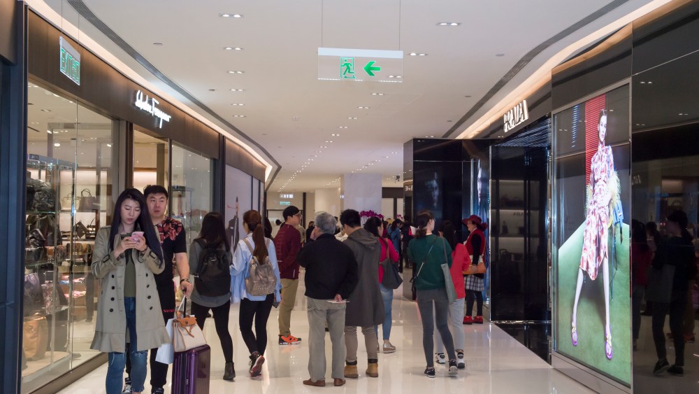 Shoppers browse the Prada and Ferragamo outlets.