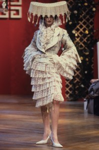 Floral patterned jacket with slit sleeves and striped trim worn with tiered, ruffled lace dress in the Givenchy Spring/Summer 1999 Couture show in Paris designed by Alexander McQueen