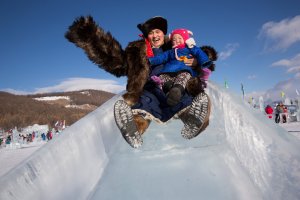 A Mongolian man and his child go down a slide at the Lake Khovsgol Ice Festival in Khatgal, Mongolia, on March 3, 2017.