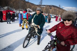 Mongolian men and women ride bikes at the Lake Khovsgol Ice Festival in Khatgal, Mongolia, on March 3, 2017.