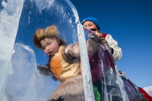 Young Mongolians go down a slide at the Lake Khovsgol Ice Festival in Khatgal, Mongolia, on March 3, 2017.