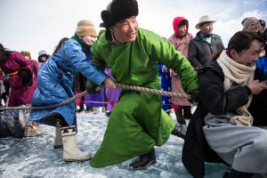 Mongolian men and women take part in a tug of war contest at the Lake Khovsgol Ice Festival in Khatgal, Mongolia, on March 3, 2017.