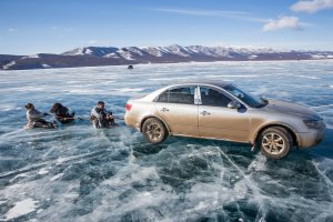 Friends are dragged by a  rope attached to the back of a moving car near the Lake Khovsgol Ice Festival in Khatgal, Mongolia, on March 4, 2017.