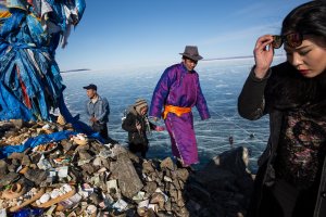Mongolian men and women pray and make offerings at an Ovoo near the Lake Khovsgol Ice Festival in Khatgal, Mongolia, on March 4, 2017.