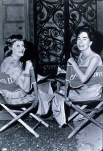 No Merchandising. Editorial Use OnlyMandatory Credit: Photo by SNAP/REX/Shutterstock (390855am)FILM STILLS OF 'WHAT EVER HAPPENED TO BABY JANE?' WITH 1962, JOAN CRAWFORD, BETTE DAVIS, DIRECTOR'S CHAIR, MOVIE SET, GRILLE, WROUGHT IRON, SMILING, SITTING, DIRECTORS CHAIR, BEHIND THE SCENE, RELAXING IN 1962VARIOUS