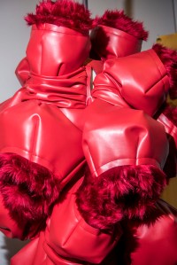 The details of the red leather and fur piece, and the latex dress is set in place.