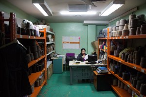 An inventory manager works in a room full of thread at Bodio's of Mongolia in Ulaanbaatar, Mongolia on March 15, 2017. Photographer: Taylor Weidman