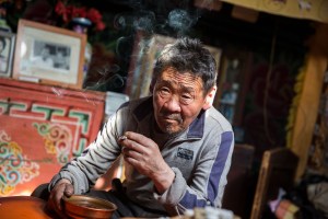 A Mongolian herder smokes a cigarette in Murun, Khovsgol Province, Mongolia.