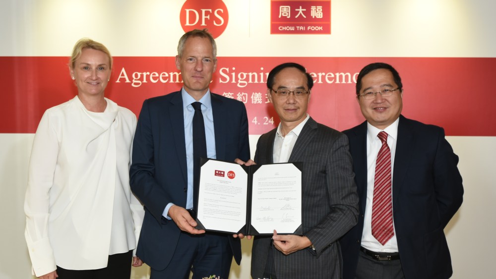 DFS chief executive officer Philippe Schaus (center left) at the signing ceremony with Chow Tai Fook managing director Kent Wong (center right).
