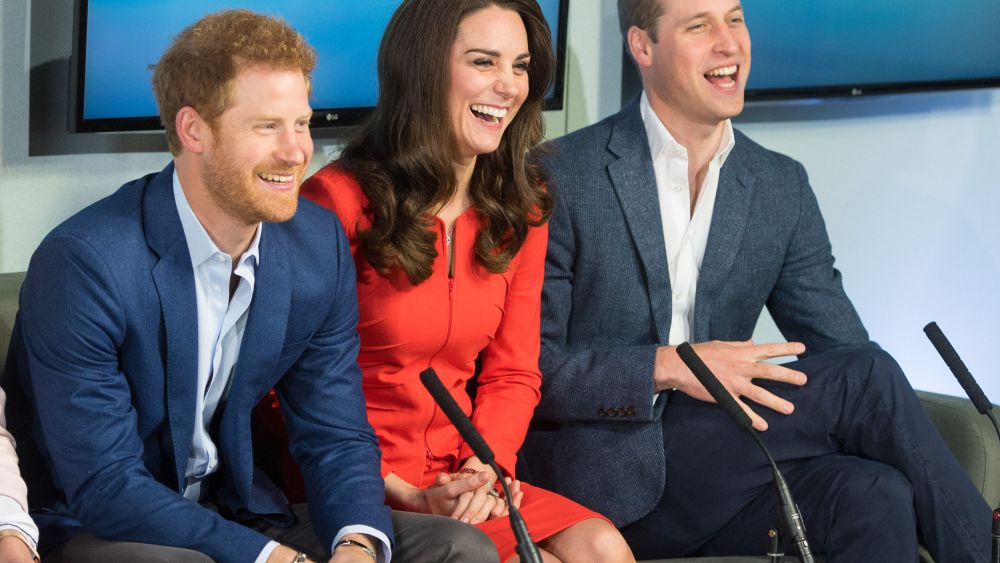Prince Harry, the Duchess of Cambridge (in Armani Collezioni) and Prince William