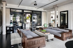 The living room has six architectural columns, ebony wood flooring and 12-foot ceilings.