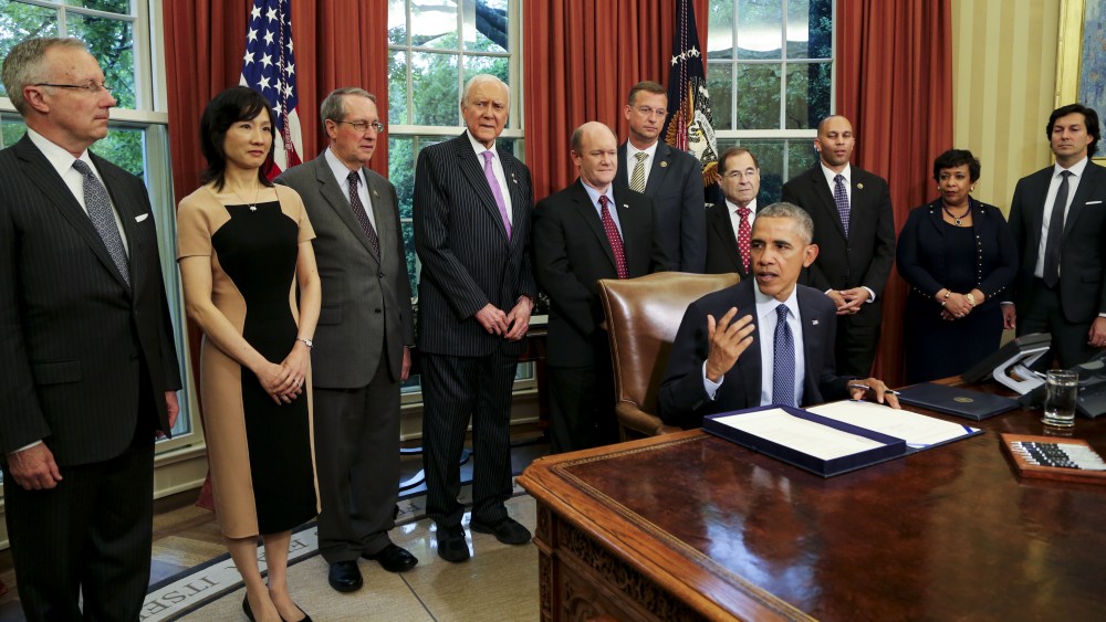 Michelle Lee (center left) during President Obama's 2016 signing of the Defend Trade Secrets Act.