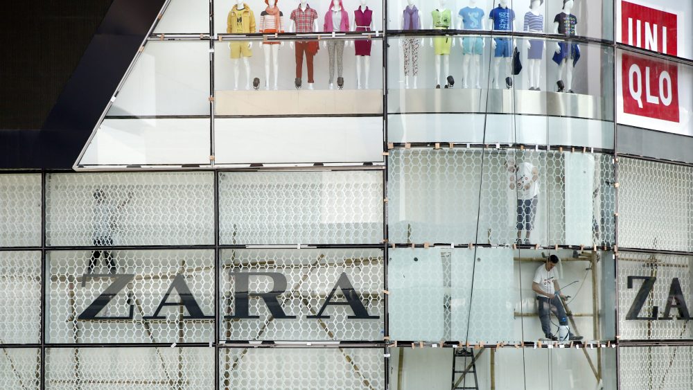 Workers put finishing touches on a Bangkok shopping mall.