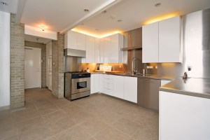 The updated kitchen with stainless steel counter tops