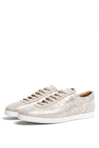 Metallic gold lace-up sneakers.
