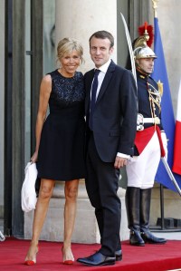 France's Economy Minister Emmanuel Macron and his wife Brigitte Trogneux pose for photographers as they arrive at the Elysee Palace in Paris, FranceFrance, Paris, France