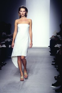 Model Kate Moss wearing Calvin Klein spring 1997 collection strapless white dress on the runway in New York