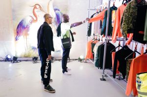 HP Virgil Abloh checks out Heron PrestonÕs collection as the designer looks on.